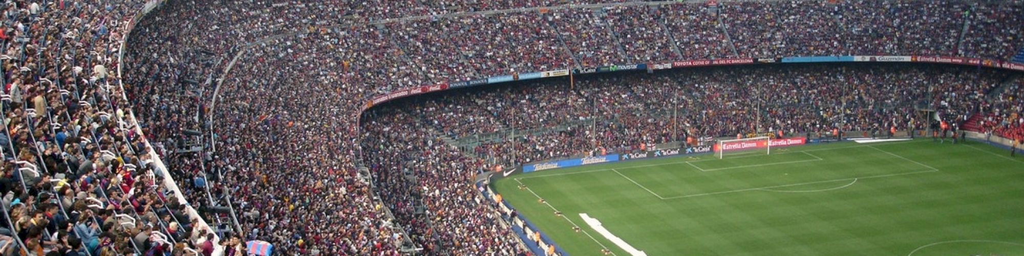 The image shows a packed football stadium with thousands of spectators in the stands, indicating a major event or match is taking place.